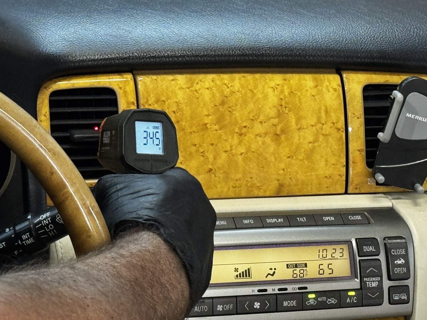 Klein Tools infrared thermometer reading 34.5°F at the center vent of a 2005 Lexus SC 430 — climate control set to 65°F, outside temp 68°F, confirming the DENSO OEM AC compressor replacement is working correctly in Atlanta